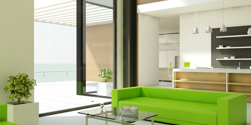 Light interior design with white walls and green couch